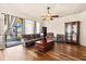 Cozy living room featuring wood-look floors and a sliding glass door at 10820 Wyandotte Dr, Clermont, FL 34711