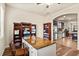 View of office space, showcasing desk, shelving, wood floors and natural light at 10820 Wyandotte Dr, Clermont, FL 34711