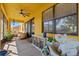 Spacious screened patio with ceiling fan, ample seating, and view to the backyard at 10820 Wyandotte Dr, Clermont, FL 34711