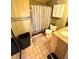 Cozy bathroom with a shower/tub combo, single sink vanity, and retro wallpaper at 1098 Henry Balch Dr, Orlando, FL 32810