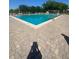 Inviting community pool with brick paved deck great for relaxing and swimming at 1098 Henry Balch Dr, Orlando, FL 32810