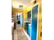 Bright kitchen with retro-inspired design, featuring blue cabinets, yellow walls, and tiled floors at 1098 Henry Balch Dr, Orlando, FL 32810