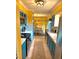 Galley kitchen featuring stylish blue cabinets, tile backsplash, and stainless steel appliances at 1098 Henry Balch Dr, Orlando, FL 32810