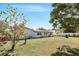 Backyard view showcasing the home's exterior and ample green space at 1109 Beatrice Dr, Orlando, FL 32810