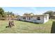 Exterior view from backyard with a well kept yard and access to house at 1109 Beatrice Dr, Orlando, FL 32810