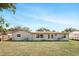 Exterior view of the home from the backyard, highlighting its well-maintained lawn at 1109 Beatrice Dr, Orlando, FL 32810