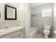 Bathroom with white tile, vanity, and a tub-shower combination, providing a fresh space at 1109 Beatrice Dr, Orlando, FL 32810