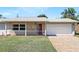 Charming house with a red front door, a brick driveway, and well-maintained landscaping at 1109 Beatrice Dr, Orlando, FL 32810