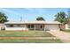 Charming single-story home with brick accents, a covered porch, a driveway, and well-maintained landscaping at 1109 Beatrice Dr, Orlando, FL 32810