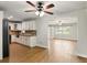 Modern kitchen with white cabinets, granite countertops, stainless steel appliances, and hardwood floors at 1109 Beatrice Dr, Orlando, FL 32810