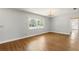 Bright living room featuring hardwood floors, a large window, and an elegant chandelier at 1109 Beatrice Dr, Orlando, FL 32810