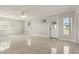 Spacious living room with tiled floors, a ceiling fan, and plenty of natural light from multiple windows at 1109 Beatrice Dr, Orlando, FL 32810
