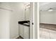 Well-lit half bathroom with modern vanity and fixtures next to a neutrally decorated room at 12557 Crayford Ave, Orlando, FL 32837