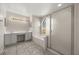 Bright bathroom featuring a double sink vanity, a large soaking tub, and a glass-enclosed shower stall at 12557 Crayford Ave, Orlando, FL 32837