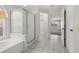 Bathroom features a glass enclosed shower and tub with tile flooring at 12557 Crayford Ave, Orlando, FL 32837