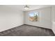 Upstairs carpeted bedroom with large window providing ample natural light at 12557 Crayford Ave, Orlando, FL 32837