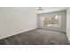Spacious bedroom with plush carpet and large window with pool views at 12557 Crayford Ave, Orlando, FL 32837