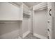 Walk-in closet features white built-in shelves, rods, and black hardware at 12557 Crayford Ave, Orlando, FL 32837