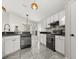 Well-designed kitchen with granite countertops, backsplash, and modern black appliances at 12557 Crayford Ave, Orlando, FL 32837