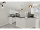 Charming kitchen with white cabinets, granite countertops, mosaic backsplash and pendant lighting at 12557 Crayford Ave, Orlando, FL 32837