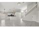Spacious living area with tile flooring, staircase, and open floor plan to the kitchen at 12557 Crayford Ave, Orlando, FL 32837