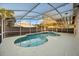Screened in pool with attached spa and tile accents at 12557 Crayford Ave, Orlando, FL 32837