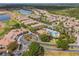 Aerial view showcasing the community amenities, pool, and landscaping, with homes in the background at 1312 Shinnecock Hills Dr, Davenport, FL 33896