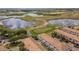 Beautiful aerial view of the surrounding golf course and lakes alongside the residences at 1312 Shinnecock Hills Dr, Davenport, FL 33896