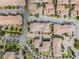 Aerial view of multiple residences showcasing tile roofs, mature trees, and a well-planned community at 1312 Shinnecock Hills Dr, Davenport, FL 33896
