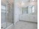 Modern bathroom showcasing a glass-enclosed shower, white cabinets, and quartz countertops at 1312 Shinnecock Hills Dr, Davenport, FL 33896