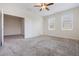 Large bedroom with two bright windows, an open closet and a doorway to another room at 1312 Shinnecock Hills Dr, Davenport, FL 33896