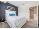 Cozy bedroom with gray accent wall, a queen-size bed, and carpeted floors at 1312 Shinnecock Hills Dr, Davenport, FL 33896