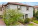 Charming two-story house featuring a tile roof, brick accents, and a well-manicured yard at 1312 Shinnecock Hills Dr, Davenport, FL 33896