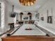 A spacious game room featuring a pool table, seating area, and wall-mounted TV at 1312 Shinnecock Hills Dr, Davenport, FL 33896