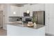 Kitchen featuring stainless appliances, gray countertops, white cabinetry, and an undermount sink on the island at 1312 Shinnecock Hills Dr, Davenport, FL 33896