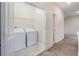 Bright laundry room with a washer, dryer, and wire shelving for storage and organization at 1312 Shinnecock Hills Dr, Davenport, FL 33896