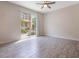 Bright, airy living room featuring wood-look tile flooring and large sliding doors with a view of the outdoor space at 1312 Shinnecock Hills Dr, Davenport, FL 33896