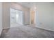 Spacious living room with neutral carpet, white walls, and multiple doorways at 1312 Shinnecock Hills Dr, Davenport, FL 33896