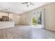 Open concept living and dining area with wood-look flooring, stainless steel appliances, and lots of natural light at 1312 Shinnecock Hills Dr, Davenport, FL 33896