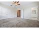 Expansive primary bedroom featuring a ceiling fan, a walk-in closet and an en-suite bathroom at 1312 Shinnecock Hills Dr, Davenport, FL 33896