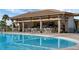 Inviting pool featuring a swim-up bar for relaxing refreshments on sunny days at 1312 Shinnecock Hills Dr, Davenport, FL 33896