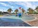 Community splash pad with interactive water features, surrounded by palm trees and lounge chairs at 1312 Shinnecock Hills Dr, Davenport, FL 33896