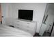Bright bedroom featuring a white dresser with a large TV and full-length mirror at 1321 Arbor Vista Loop # 325, Lake Mary, FL 32746