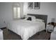 Inviting bedroom featuring a plush bed, modern window shutters, and minimalist decor at 1321 Arbor Vista Loop # 325, Lake Mary, FL 32746