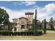 Beautiful building featuring a fountain, manicured lawn, arched windows, and decorative turret at 1321 Arbor Vista Loop # 325, Lake Mary, FL 32746