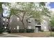 Attractive multi-Gathering building with neutral paint, trimmed windows, lawn area, and mature shade tree at 1321 Arbor Vista Loop # 325, Lake Mary, FL 32746