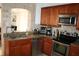 Kitchen features stainless steel appliances, granite countertops, and wood cabinetry at 1321 Arbor Vista Loop # 325, Lake Mary, FL 32746