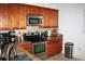 View of the kitchen featuring stainless steel appliances, wood cabinets and granite countertops at 1321 Arbor Vista Loop # 325, Lake Mary, FL 32746