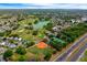 Gorgeous aerial view of community featuring a golf course, lake, baseball field and tennis courts at 1329 Paradise Dr, Lady Lake, FL 32159