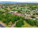 Aerial view of the neighborhood showcasing the home's proximity to lush greenery and a nearby golf course at 1329 Paradise Dr, Lady Lake, FL 32159